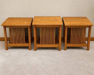 ge- This set includes three beautifully crafted Mission style side tables made from oak wood, showcasing a classic design with vertical slat sides and rich wood grain. The set comprises two larger tables measuring 24" x 22" x 26" and one slightly smaller table measuring 21" x 22" x 26". These side tables feature a warm, natural oak finish that highlights the durability and craftsmanship of the wood, making them a perfect addition to any living room or seating area.