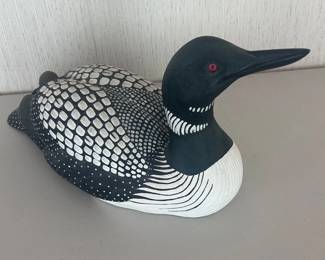 ad- Decorative Common Loon decoy by wildlife artist and renowned carver Sam Nottleman, produced for Wild Wings. The underside retains its original Certificate of Authenticity, identifying the piece as a reproduction of an original woodcarving by Nottleman and noting that it was meticulously hand-painted by skilled artisans. This example is Limited Edition No. 303 of 2,900 and is dated ©1996 Sam Nottleman. Nicely detailed black-and-white plumage with distinctive red eyes and classic loon coloration. Measurements: approximately 20” long × 9” wide × 9.5” tall.