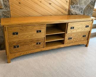 hd- This Multi - drawer oak storage cabinet features classic dovetail joinery, enhancing both its durability and aesthetic appeal. Crafted from rich oak, the cabinet measures 30.5 inches tall, 84.5 inches wide, and 25 inches deep, providing ample storage space with multiple drawers and open shelves. The cabinet's natural oak finish highlights the beautiful wood grain, while the metal drawer handles add a touch of vintage charm. Ideal for organizing and displaying various items, this piece offers a perfect blend of functionality and timeless design.