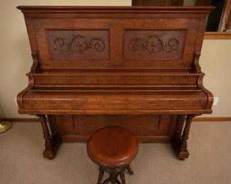 aj- Beautiful W.E. Wheelock & Co. upright piano featuring an unusually elaborate wood cabinet believed to have been custom handmade or extensively customized by the previous owner. The case displays striking figured wood grain, carved scrollwork panels, substantial molding, turned supports and detailed woodworking throughout. The piano is marked W.E. Wheelock & Co., New York on the interior. The date of the piano and the date of the custom cabinet work have not been confirmed. Includes the coordinating adjustable wood piano stool shown, featuring turned legs, stretchers and decorative metal claw-style feet. Measures approximately 55” H x 62” W x 27.5” D. An unusual combination of a W.E. Wheelock & Co. upright piano and extensive custom cabinetry. In very good condition overall. Playing, tuning and mechanical condition have not been professionally evaluated. Please review photos for condition.