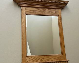 gg- This solid wood wall mirror features a timeless classic crown molding design, adding elegance and sophistication to any room. Measuring 37.5 inches tall and 34 inches wide at the top, the mirror is crafted from high-quality wood with a natural finish that highlights the wood grain. Its sturdy frame and detailed molding make it a perfect decorative and functional piece for your home.