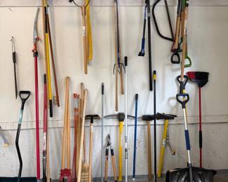 hy- This assortment of yard tools features a variety of essential gardening and outdoor maintenance equipment, including rakes, shovels, hoes, pruners, and brooms. The tools showcase sturdy wooden and metal handles, offering durability and comfortable grip. Ideal for all your yard maintenance needs, this set combines practicality with versatility for efficient landscaping and gardening.