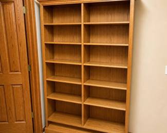 gy- This light oak wooden bookcase features a classic crown molding that adds an elegant touch to any room. It includes adjustable shelving, allowing you to customize the storage space to fit your needs. Measuring 78 inches tall, 48 inches wide, and 12 inches deep, this sturdy and spacious bookcase is perfect for organizing books, decor, and more in your home or office.