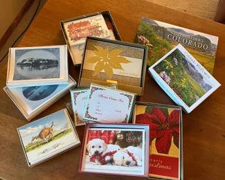 mb- This diverse collection features multiple sets of cards, each presented in unique, decorative boxes. Included are charming designs such as vintage black-and-white photographs, colorful nature and wildlife scenes including flowers and a cow, as well as festive Christmas themes with poinsettias and adorable puppies. The cards vary in style and size, with detailed artwork printed on high-quality cardstock. The boxes themselves range in colors and motifs, adding an elegant touch to each set, making this collection perfect for stationery lovers and gift-giving.
