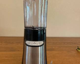 ja- This Cuisinart compact portable blending and chopping system is designed for versatile kitchen use. It features a sleek stainless steel and black plastic body, combining durability with modern aesthetics. Standing approximately 12 inches tall and 3.5 inches wide, it is ideal for single-serve smoothies, chopping, and blending tasks. The unit includes simple control buttons for pulse, low, and high speeds, enhancing usability. Its clear blending container allows for easy monitoring of contents, making it a practical and efficient addition to any kitchen.