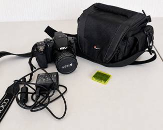 ar- Nikon COOLPIX P510 digital bridge camera featuring a powerful 42x optical zoom NIKKOR lens. Camera includes Lowepro padded carrying bag, Nikon EH-69P AC adapter/charger, battery, lens cap, and neck strap. Features include: ● 16.1-megapixel CMOS sensor ● NIKKOR 42x wide optical zoom lens ● 4.3–180mm lens (24–1000mm equivalent) ● Built-in GPS ● Full HD video capability ● Rear LCD display ● Electronic viewfinder ● Built-in flash Camera powers on and the LCD display is functioning, as shown in photos. Overall appears to be in good pre-owned condition with normal signs of use. Please review photos for condition and included accessories.