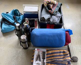ht- This camping and sporting goods set features a variety of essential outdoor equipment, including three stainless steel thermoses with insulated caps for hot or cold beverages. The kit also includes a durable, colorful striped blanket, a blue sleeping bag, and multiple bags for convenient storage and transport. A black sportsman's multi-tool combo pack with pliers, a knife, scissors, other tools is included in its original packaging, and a fly fishing rod making this lot a perfect choice for adventuring the outdoors.