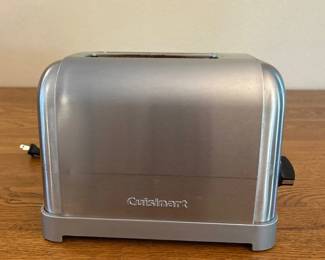 jn- This Cuisinart toaster features a sleek stainless steel exterior with a compact design measuring approximately 9 inches wide. It includes adjustable browning control with a rotary dial and a slide lever for easy operation. The toaster is designed for 2 slices and has a modern, brushed metal finish that fits well in any kitchen setting.