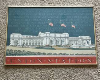 dv- Framed architectural poster depicting Union Station in Washington, D.C., created by noted architectural illustrator Carlos Diniz (1928–2001) and marked “DINIZ ’88 / Carlos Diniz Associates.” The design commemorates Union Station’s 1908–1988 anniversary era and features a detailed architectural rendering of the station beneath a quotation attributed to Daniel H. Burnham, with bold “UNION STATION – WASHINGTON DC” lettering across the bottom. Diniz was a prominent architectural illustrator whose studio, Carlos Diniz Associates, produced presentation artwork for major architectural projects; Union Station’s rehabilitation was among the projects represented in his work. Presented in a simple gold-tone metal frame. Visible condition appears good overall with light age/display wear; please review photographs for exact condition.