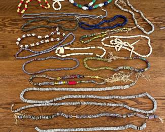 ms- A diverse collection of handmade beaded necklaces featuring an array of colors, sizes, and materials. This assortment includes vibrant glass beads, smooth wooden beads, and intricately decorated ceramic beads. The necklaces showcase a variety of textures and designs, from tightly strung small beads to larger, statement pieces with colorful patterns. Natural fibers and string materials are used in some pieces, adding rustic charm. These lightweight, multi-colored necklaces offer unique artistic appeal, perfect for collectors or fashion enthusiasts seeking distinctive accessories.