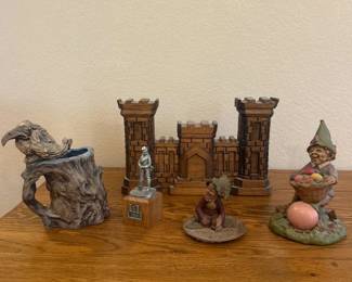 kr- This intricately designed medieval castle collectible is handcrafted from rich, dark wood, showcasing detailed brickwork and battlements. Measuring approximately 12 inches wide, 9.5 inches tall, and 2.5 inches deep, it serves as a striking centerpiece for any medieval or fantasy-themed display. Its warm brown tones and natural wood grain add an authentic and rustic charm, making it a unique addition to any collection of medieval artifacts or decorative pieces. Along with 2 nome figurines, a handmade troll with friend mug and a pewter solder.