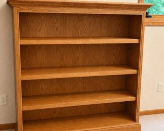 gx- This elegant set of two light oak wooden bookcases features classic crown molding and adjustable shelving, providing both style and versatility for your storage needs. Each bookcase measures 52 inches tall, 52 inches wide, and 14 inches deep, making them ideal for displaying books, decor, or collectibles. Crafted from durable light oak, these bookcases bring a warm and timeless look to any room.