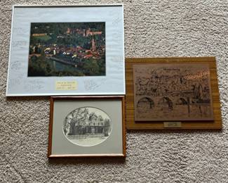 el- This collection includes three distinct framed artworks: a vibrant aerial photograph of Heidelberg with personalized messages on the white matting, a detailed plaque of Heidelberg mounted on a wooden backing, and a finely detailed black and white sketch titled 'Custer House' signed by Adia Wilie and dated September 1986. The set showcases diverse materials including photographic print, wood engraving, and pencil or ink drawing on paper, all framed in wood or white frames. The Heidelberg pieces highlight the city’s charm and architecture, while the sketch offers a nostalgic, historic view. This diverse set is perfect for collectors or those looking to add a blend of color, craftsmanship, and history to their decor. Wood Frame: 12in x 15in Metal Frame: 20in x 23.7in Copper Canvas: 14.5in x 18.5in