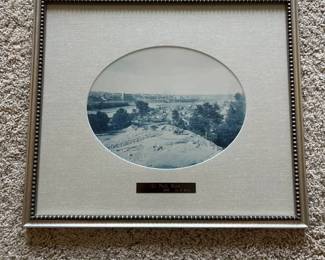 dt- The attribution appears consistent with noted 19th-century photographer Henry Peter Bosse (1844–1903), an engineer, cartographer and photographer associated with the U.S. Army Corps of Engineers who extensively documented the Upper Mississippi River region during the 1880s and 1890s. Bosse’s surviving photographs include views of St. Paul taken in 1885 and are particularly known for their characteristic blue-toned cyanotype process. The circular-format image provides an elevated panoramic view across the developing St. Paul landscape and Mississippi River corridor. It is professionally presented under glass with fabric matting, decorative silver-tone framing and engraved identification plaque. Believed to be a Henry P. Bosse cyanotype photograph dating to 1885 based on the identification plaque and visible characteristics; the photograph has not been removed from the frame or independently authenticated.