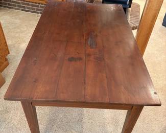 hg- This solid wood dining table features a rich, dark stained finish that highlights the natural grain and character of the wood. Measuring 31 inches tall, 53.5 inches long, and 32.5 inches wide, it offers ample space for family meals or gatherings. The table showcases a sturdy, timeless design with clean lines and tapered legs, making it a versatile addition to both traditional and contemporary dining rooms.