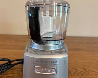 jl- This Cuisinart 4-Cup Food Processor features a compact design with a clear plastic work bowl and a silver base, ideal for small to medium food preparation tasks. The processor includes easy-to-use Chop and Grind functions, perfect for chopping, dicing, and grinding ingredients efficiently. The 4-cup capacity work bowl is made from durable transparent material allowing clear visibility of contents, while the silver base offers a sleek and modern look. Its small footprint and manageable size make it convenient for countertop use and easy storage.