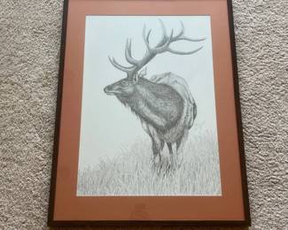 cz- Striking signed and numbered wildlife art print by illustrator Cheri Ziebart, featuring a large bull elk standing among tall grasses with a mountainous landscape in the background. The detailed monochromatic composition showcases intricate linework throughout the elk, impressive antlers, vegetation, and distant scenery. The artwork is hand signed “Cheri Ziebart” and numbered 28/100, indicating a limited edition of 100. Cheri Ziebart has documented professional work as an illustrator and graphic designer, including artwork associated with wildlife and natural-resource publications. The 1993 Transactions of the North American Wildlife and Natural Resources Conference specifically credits “Artwork by Cheri Ziebart.” Presented under glass with a rust/burnt-orange mat and dark wood-tone frame. A particularly appropriate piece for collectors of wildlife, elk, Western, sporting, or outdoor-themed artwork.
