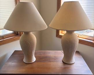 go- This elegant pair of ceramic lamps features a textured surface with an embossed leaf motif, adding a natural and artistic touch to any room. Each lamp stands 28.5 inches tall and is complemented by a 19-inch wide flared fabric shade that softly diffuses light for a warm, inviting ambiance. The neutral color palette and unique design make these lamps perfect for both classic and contemporary interiors.
