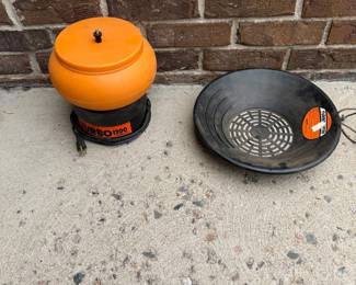 ih- This Lyman Turbo 1200 tumbler is designed for efficient cleaning and polishing of small parts, ideal for shooting enthusiasts. It features a bright orange, durable plastic drum with a secure lid, paired with a black base unit for stability. The accompanying black sifter allows for easy separation of media and brass casings. Compact and portable, this tumbler is powered by a standard electric cord. Perfect for reloading ammo cartridges.