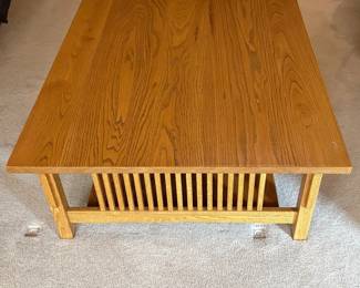 gf- This Mission Style coffee table is crafted from solid wood, showcasing a warm natural finish that highlights the wood grain beautifully. Measuring 16.5 inches tall, 44 inches wide, and 36.5 inches deep, it offers a spacious rectangular surface perfect for living rooms. With unique slatted wood panels on either side. Its sturdy construction and timeless Mission style make it a versatile addition that complements a variety of decor styles.