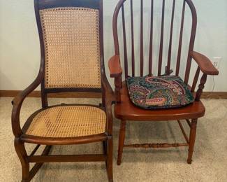 hk- This set features two charming vintage chairs. A rocking chair crafted from rich wood with elegantly curved armrests showcasing intricate woven cane seating and backrest, providing both comfort and classic style. The second with elegant armrests for dining or sitting in a room. The first chair measures 40 inches tall, 24 inches wide, and 19 inches deep, while the second is slightly smaller at 39 inches tall, 22 inches wide, and 18 inches deep. The warm wood tones and textured cane add a rustic yet refined touch, making these chairs perfect additions for traditional or country-inspired interiors.