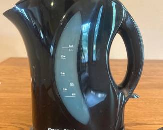 jr- This Proctor Silex Electric Tea Pot offers a convenient and efficient way to boil water quickly. Featuring a compact design in a sleek black color, it includes a clear water level indicator marked with measurements up to 1.5 liters for easy monitoring. The tea pot stands approximately 8 inches tall, making it ideal for small kitchen spaces, dorm rooms, or office use. Crafted from durable plastic material, it has an ergonomic handle for comfortable pouring. The base allows for cordless operation and easy lifting. Its modern look and practical size make it a great addition to any kitchen.