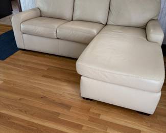 Leather loveseat with chaise. Available for presale.