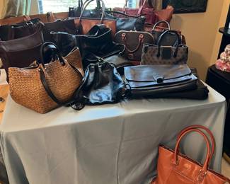 collection of designer handbags including Coach and Dooney & Burke