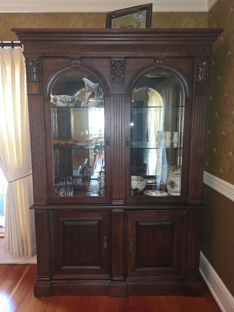 Bernhardt Neoclassical Revival piece featuring arched glass doors with beveled edges and detailed carved accents.