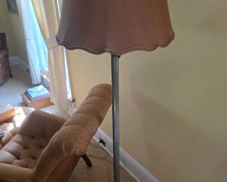 vintage torchiere floor lamp features a fluted metal standard, a scalloped brown fabric shade, and a distinctive illuminated nightlight bowl near the heavy cast base.