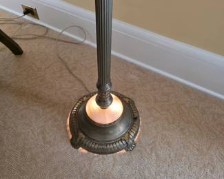 vintage torchiere floor lamp features a fluted metal standard, a scalloped brown fabric shade, and a distinctive illuminated nightlight bowl near the heavy cast base.