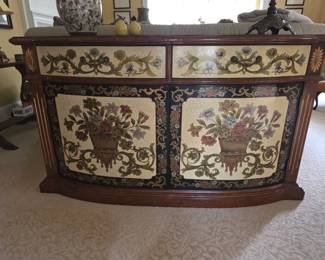The Hooker Furniture Seven Seas Serpentine floral-decorated credenza features a curved front and hand-painted basket and floral motifs