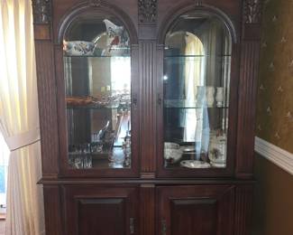 Bernhardt Neoclassical Revival piece featuring arched glass doors with beveled edges and detailed carved accents.