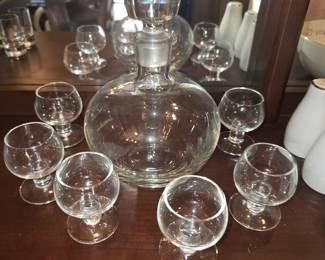 classic Tinka Mid Century Crystal Glass Aperitif Decanter Set designed by A.D. Copier for Royal Leerdam, characterized by its spherical shape and matching short-stemmed glasses