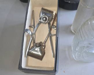 vintage manual hand hair clippers resting inside a small cardboard storage box