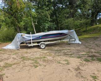 Fishing Boat and trailer. Inner portion of boat has product for new carpeting.