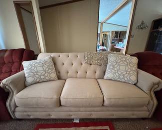 Sofa with Diamond tufted backrest and Nailhead trim with rolled arms