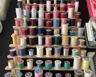 Vintage Sewing Thread Spools on Wooden Rack