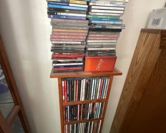 Lot 55: Tall wooden CD storage tower with stacked CD cases