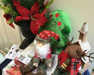 Lot 48: Christmas greenery arrangement with plush Santa and reindeer and decorative church