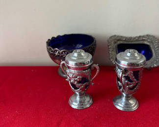 Lot 117: Ornate silver-tone salt and pepper shakers with cobalt blue glass bowl and frame