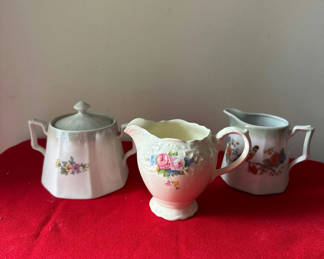 Lot 168: Three floral porcelain creamer and sugar bowl set