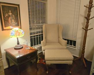 Winged chair with ottoman, colorful lamp shade and traditional framed wall-art