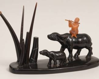 Herdboy on a water buffalo in pastoral landscape