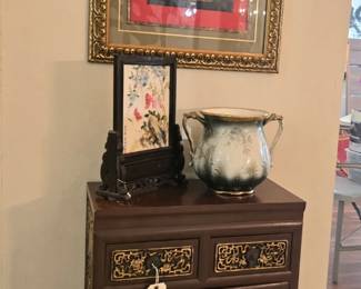 Small cabinet with gold gilt artwork and other eye-catching decor