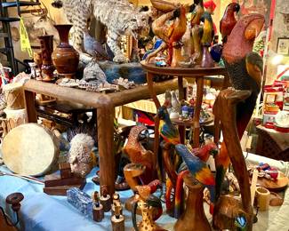 Wood carved animal statues and taxidermy bobcat