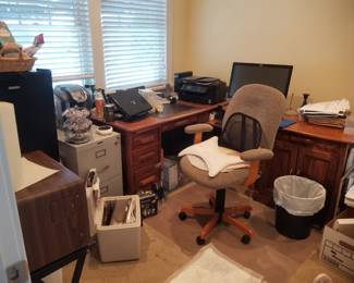 Metal file cabinet; L-shaped executive desk; swivel office chair