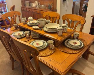 Wooden dining table with additional leaf.