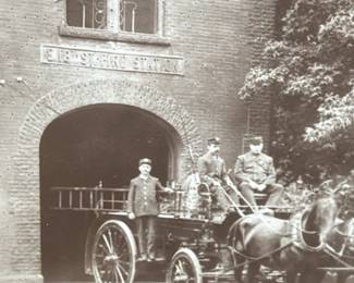 Old black & white photographs. Firestation. Horse drawn ladder wagon. Firemen.