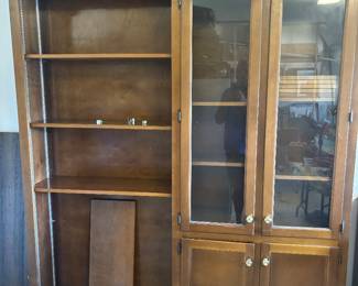 Dark Maple bookcase w adjustable shelves and 4 doors $ 450.00. 64”w 13”d 84”t